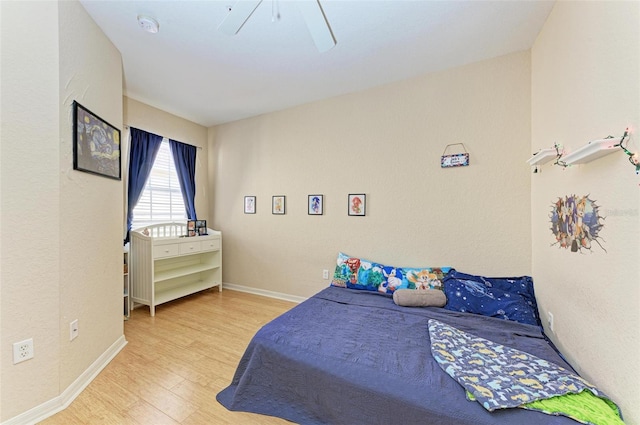 bedroom with light wood-type flooring and ceiling fan