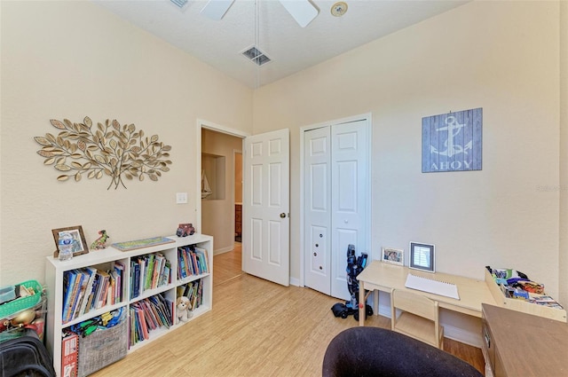 office with light hardwood / wood-style floors and ceiling fan