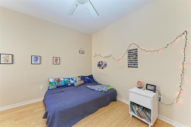 bedroom with hardwood / wood-style flooring and ceiling fan