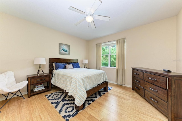 bedroom with light hardwood / wood-style floors and ceiling fan