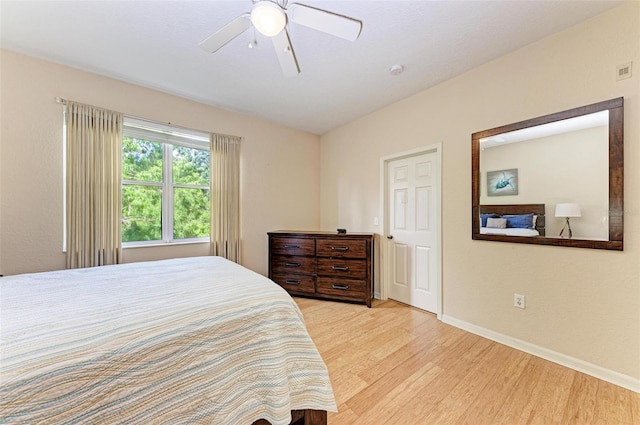 bedroom with light hardwood / wood-style flooring and ceiling fan