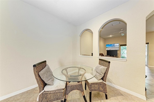 tiled dining area with ceiling fan