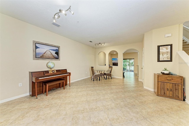 sitting room featuring rail lighting and a textured ceiling