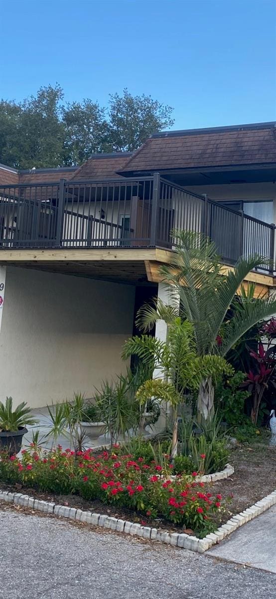 exterior space featuring roof with shingles and stucco siding