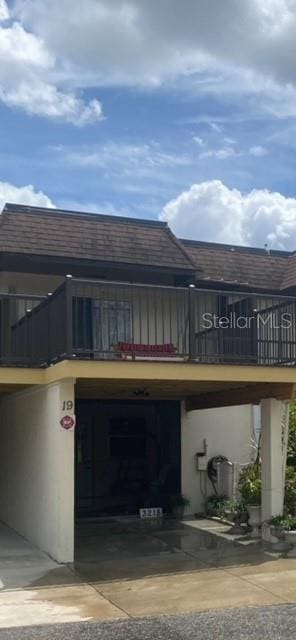 exterior space with a garage and a balcony