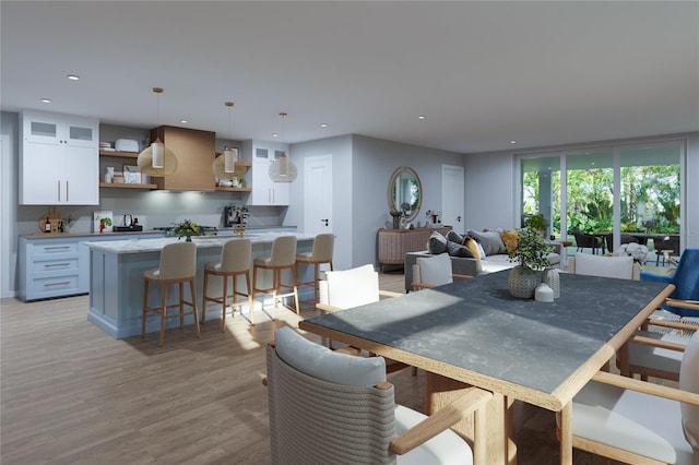 dining space with recessed lighting and light wood-style flooring