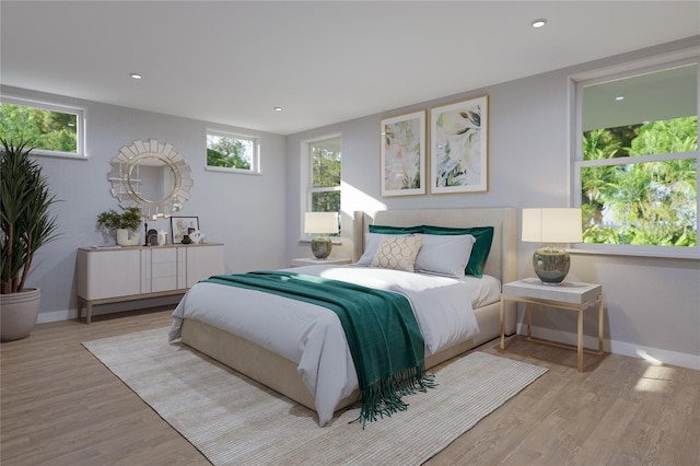 bedroom featuring baseboards, wood finished floors, and recessed lighting