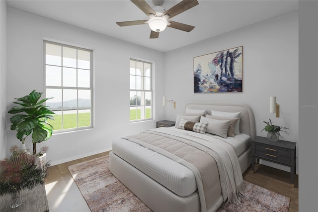 bedroom featuring ceiling fan, baseboards, and wood finished floors