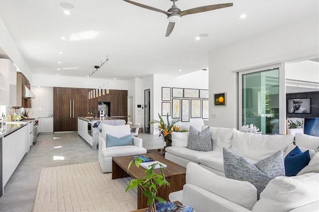 living room featuring ceiling fan and sink