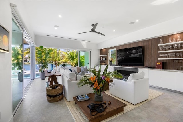 living room with ceiling fan and indoor bar