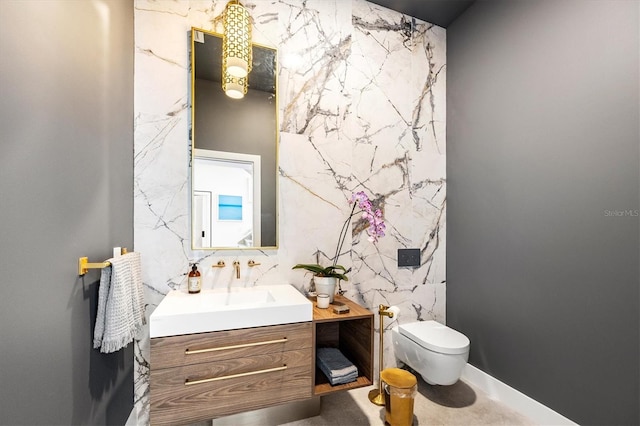 bathroom featuring vanity, tile walls, and toilet