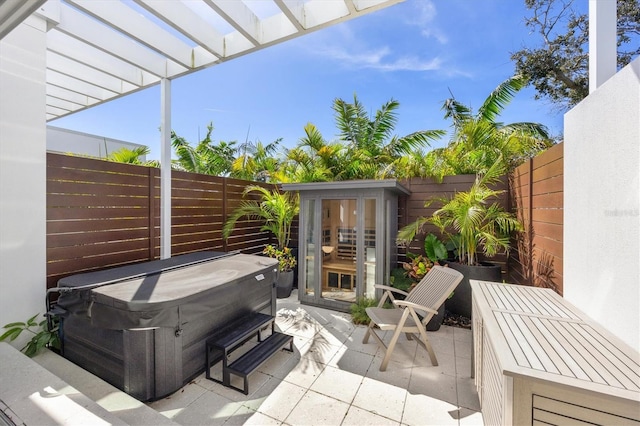 view of patio / terrace with a pergola and a hot tub