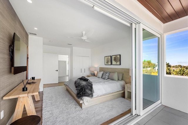 bedroom with hardwood / wood-style floors, a closet, and ceiling fan