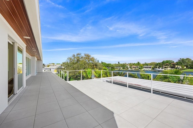 view of patio / terrace featuring a water view and a balcony