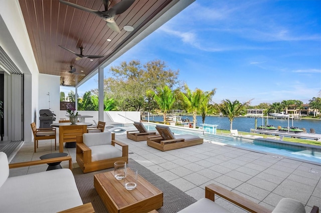 view of patio featuring pool water feature, ceiling fan, and a water view