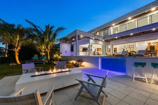 view of swimming pool featuring a fire pit and a patio