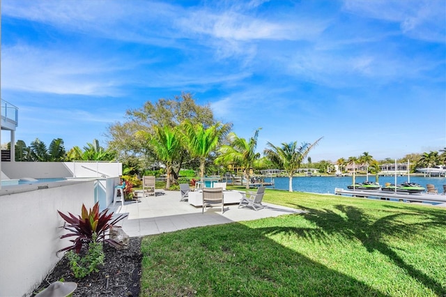 view of yard with a water view and a patio area