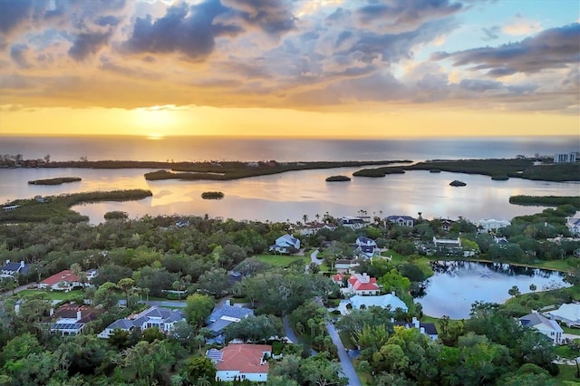 aerial view at dusk with a water view