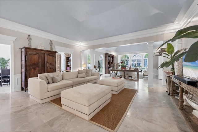 living room featuring ornate columns and ornamental molding