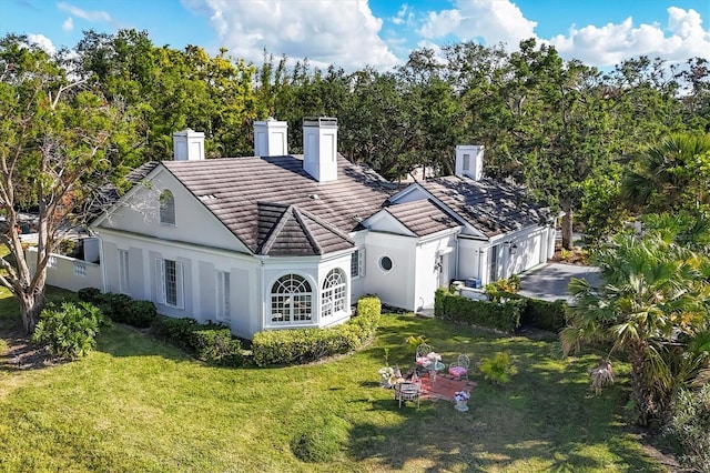 back of property featuring a lawn