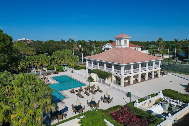 rear view of property featuring a patio area and a community pool