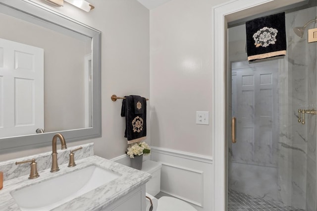 bathroom with toilet, an enclosed shower, and vanity