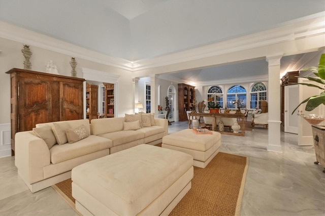 living room with decorative columns and ornamental molding