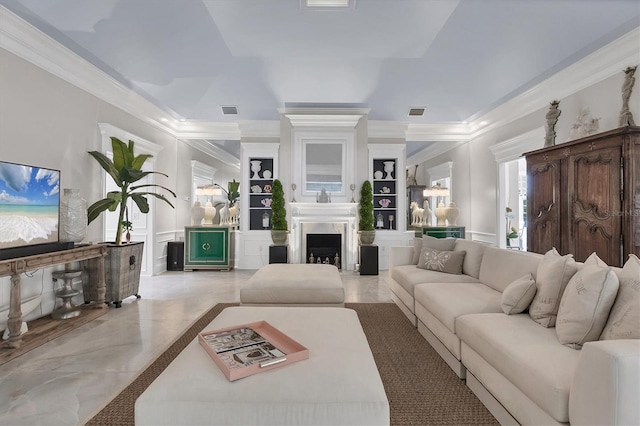 living room featuring ornamental molding and built in features