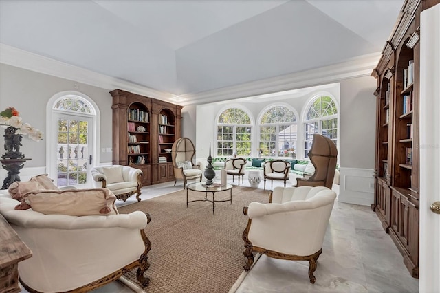 sitting room with crown molding and a healthy amount of sunlight