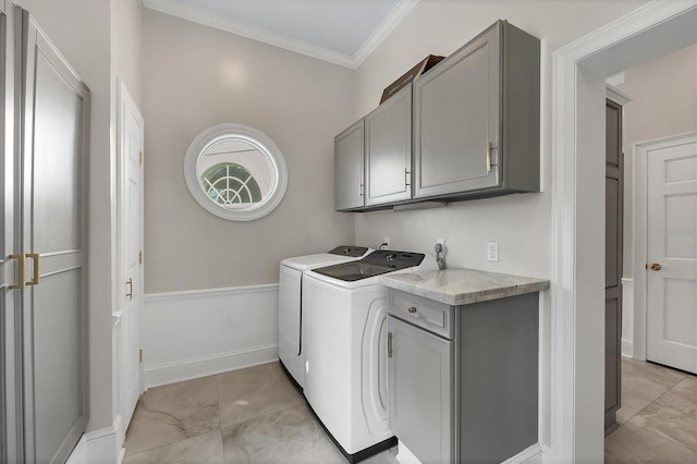 clothes washing area with separate washer and dryer, cabinets, and ornamental molding