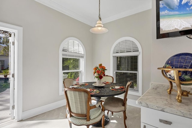 dining space featuring light tile patterned flooring, a wealth of natural light, and crown molding