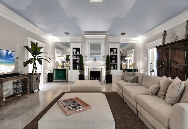 living room featuring crown molding and built in features