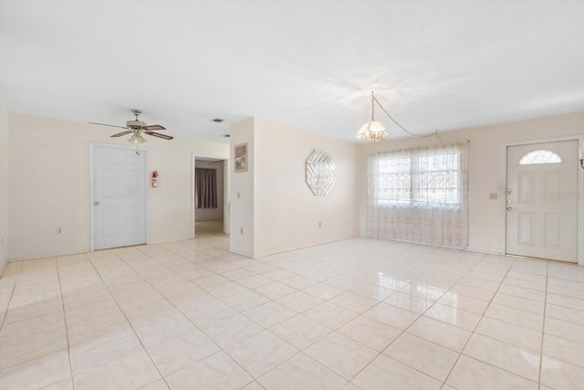 interior space with ceiling fan with notable chandelier