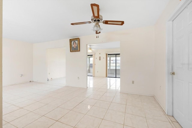 empty room featuring ceiling fan and light tile patterned floors