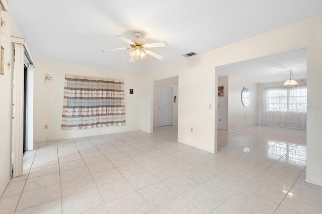 tiled spare room featuring ceiling fan