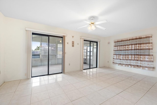 empty room featuring light tile patterned flooring and ceiling fan