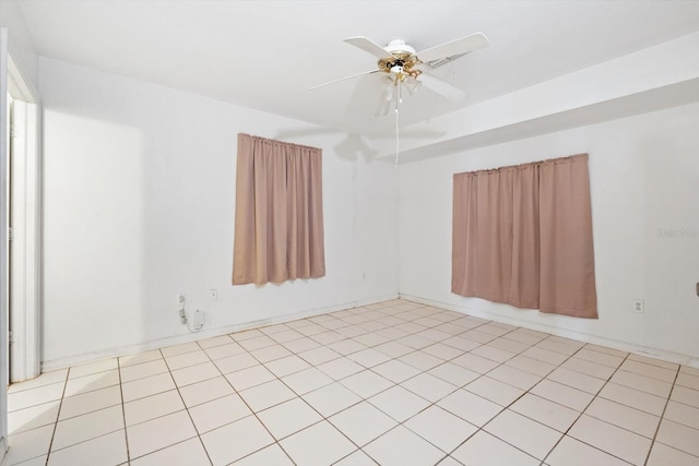 empty room with light tile patterned floors and ceiling fan