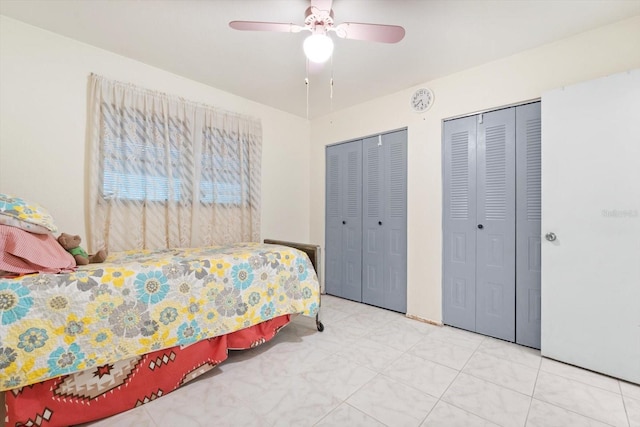 bedroom featuring two closets and ceiling fan