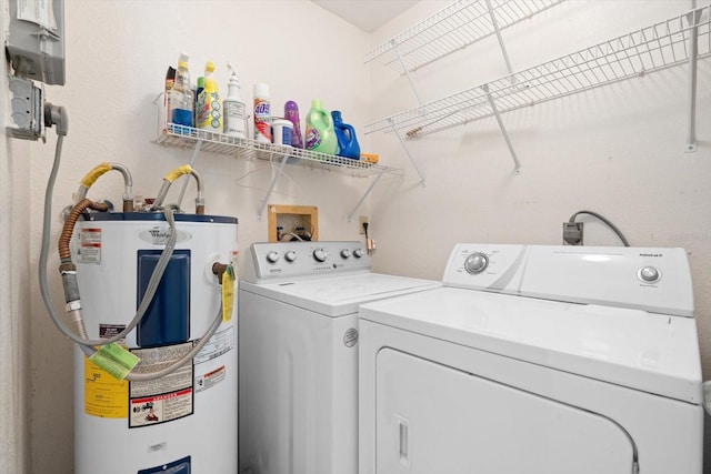 laundry room with separate washer and dryer and water heater