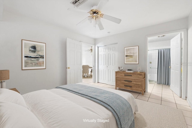 6352 Coniston Ter, North Port, FL 34287 - bedroom featuring light tile patterned floors, a closet, ensuite bathroom, and ceiling fan
