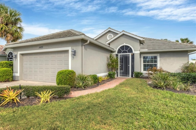 ranch-style home with a front lawn and a garage