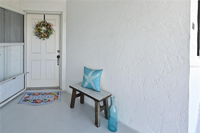 doorway to property with stucco siding