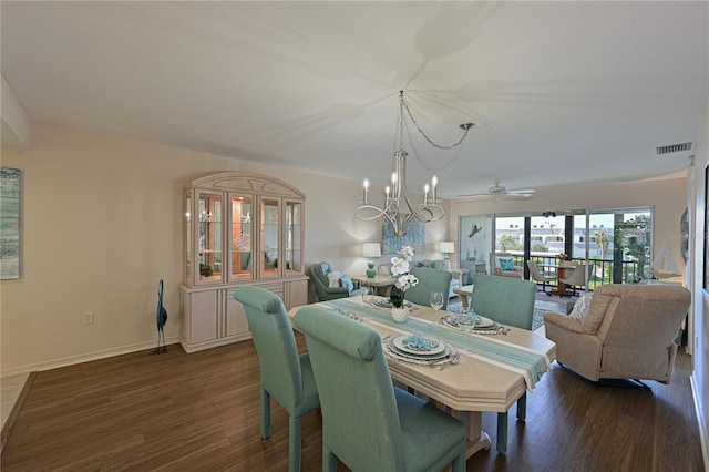 dining area with baseboards, dark wood finished floors, visible vents, and an inviting chandelier