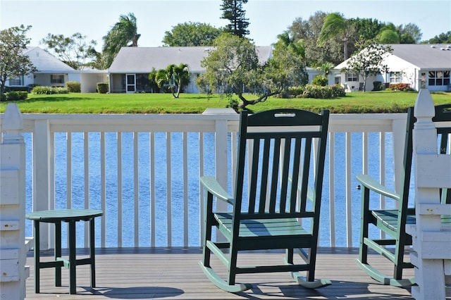 dock area with a residential view and a lawn