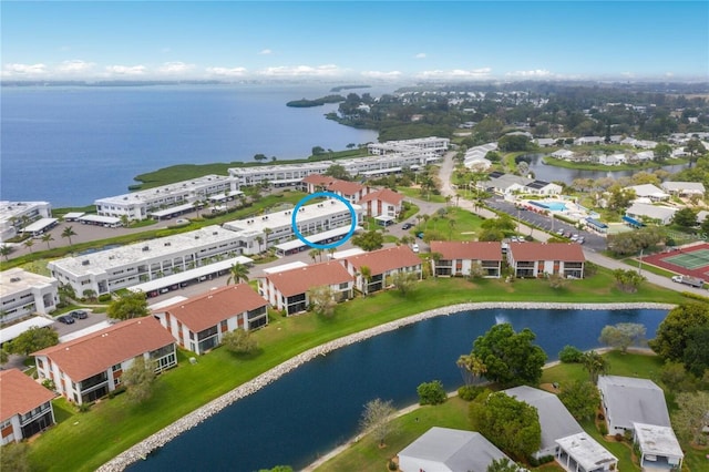 drone / aerial view featuring a water view and a residential view