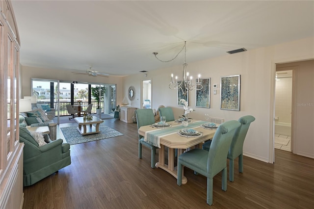 dining room with baseboards, visible vents, dark wood finished floors, and ceiling fan with notable chandelier