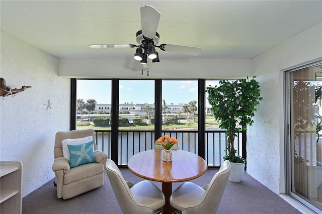 sunroom featuring a wealth of natural light and a ceiling fan