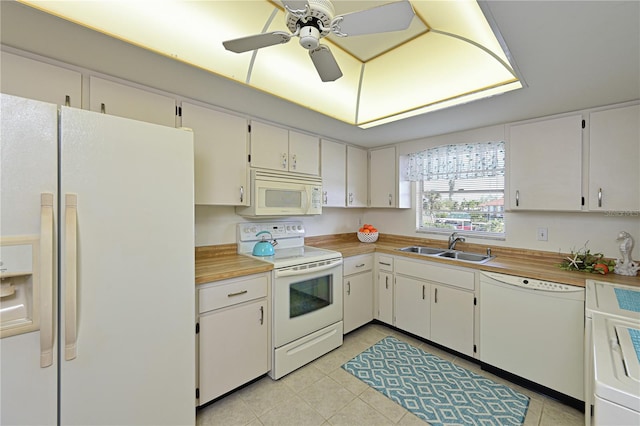 kitchen with white appliances, white cabinets, a sink, and light countertops