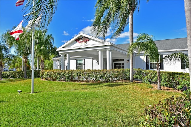 neoclassical home with a front lawn