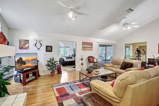 living room featuring plenty of natural light, ceiling fan, and light hardwood / wood-style flooring